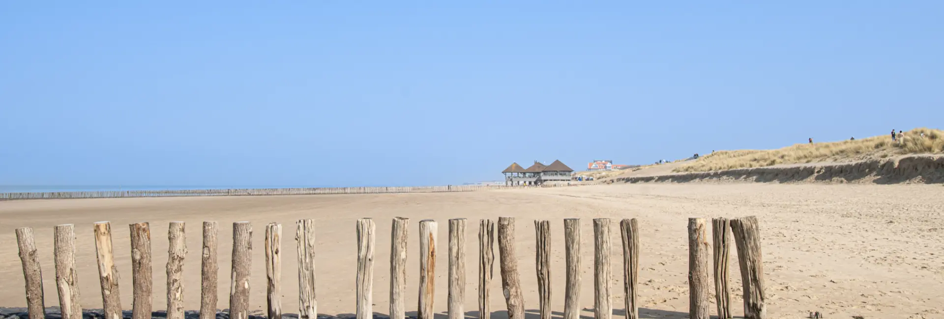 Strand zicht palen paviljoen blauwe lucht